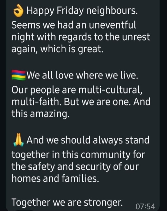 Screenshot of a WhatsApp message to a neighbourhood group wishing neighbours a happy Friday, noting an uneventful night, and saying that Mauritians are multi-cultural and multi-faith but one, and stronger together